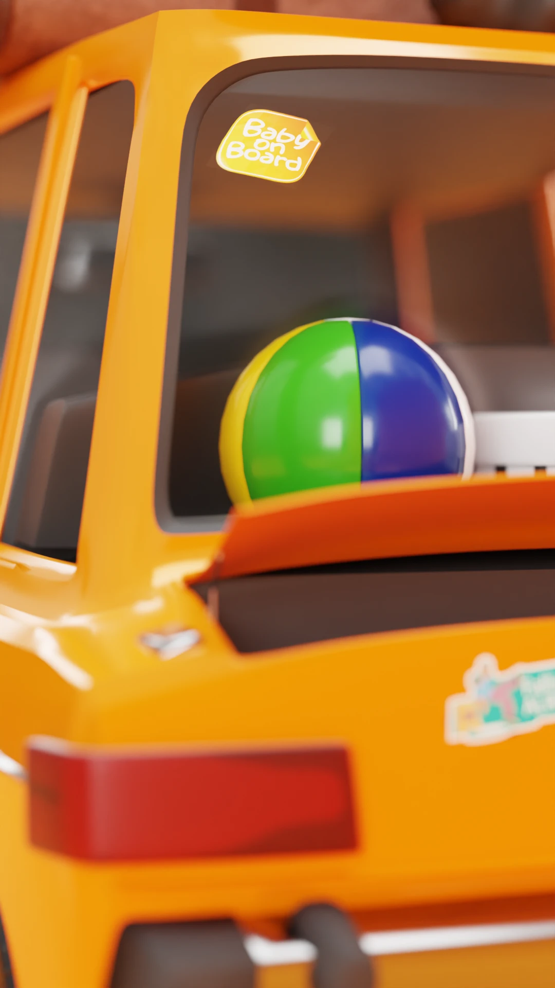 Close-up of the car's back window with a Baby on Board sticker and a beach ball
